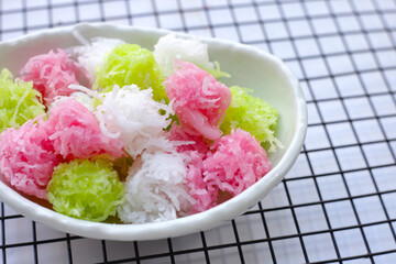 Sweet coconut balls, crispy coconut candies (Maprao Gaew). Thai traditional dessert