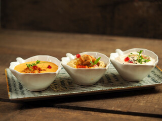 Appetizers with hummus, paprika and salmon cream