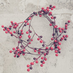 christmas decoration red berries against cement wall