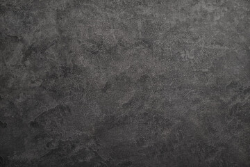 Texture of black polished concrete background. Dark old wallpaper with cement texture. Nature wall concept, surface mockup. Empty rough cement wall or floor background. Top view, close up, copy space