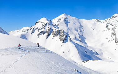 Fototapeta na wymiar Skiiers heading into the backcountry, Swiss Alps