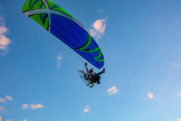 Paragliding in the sky. Tandem paraglider flying over Tiradentes Minas Gerais city and mountains in bright sunny day.