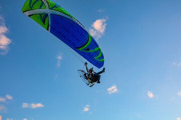 Paragliding in the sky. Tandem paraglider flying over Tiradentes Minas Gerais city and mountains in...