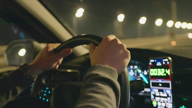 Drive night taxi street road man hand smartphone car town city