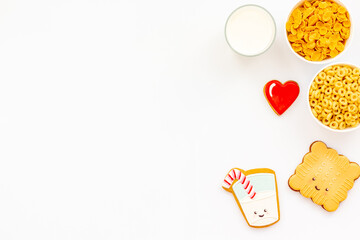 Kids breakfast with milk and funny cookies with cornflakes