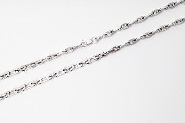 Subject photography of silver chains on a white background