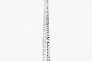 Subject photography of silver chains on a white background