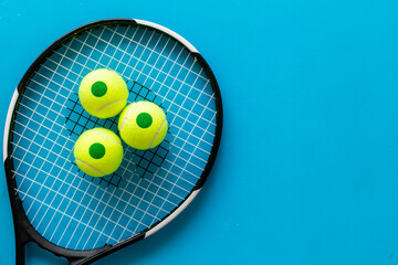 Tennis racquet and balls, top view. Sport games background