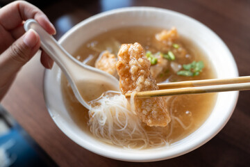 Delicious fried narrow-barred Spanish mackerel fish fillet with rice and noodles in thick soup in Taiwan.