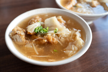 Delicious fried narrow-barred Spanish mackerel fish fillet with rice and noodles in thick soup in Taiwan.