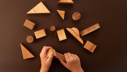 Child hands playing with wooden blocks