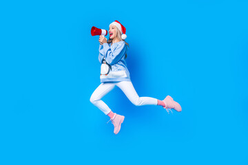 Obraz premium Full body photo of running jumping trampoline funny lady santa claus speech loudspeaker announce new year isolated on blue color background