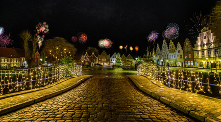 Charming town bathed in festive lighting and fireworks, creating a romantic atmosphere for New...