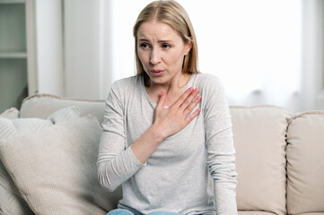 worried woman feeling cardiac pain and difficulty breathing