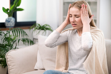 stressed woman feeling acute headache and suffering from migraine