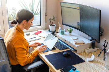 Computer programmer working from home. Teleworking concept. Business woman using a tablet.
