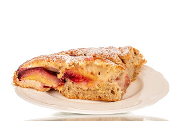 Sweet homemade pie with plums on a white ceramic saucer, macro, isolated on white background.