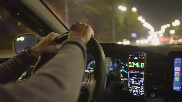 Drive night taxi street road man hand smartphone car town city