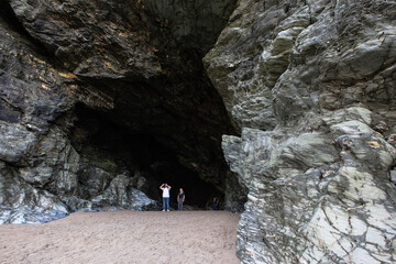 The entrance to a large cave in Cornwall photographed at low tide.