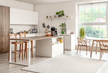 Interior of light kitchen with modern coffee machine