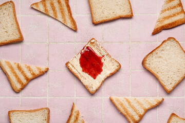 Tasty toasts with butter and jam on pink tile background