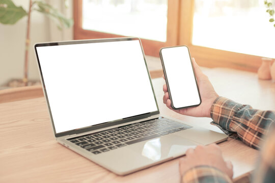 computer screen,cell phone blank mockup.hand woman work using laptop texting mobile.white background for advertising,contact business search information on desk in cafe.marketing,design