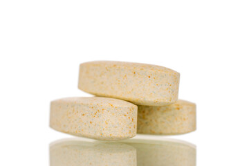 Three medical pills, macro, isolated on white background.