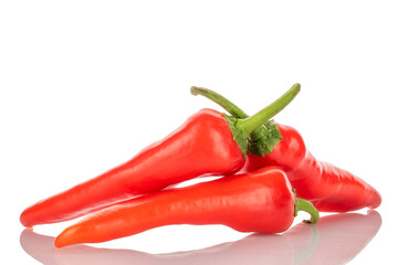 Three sweet red peppers, macro, isolated on white background.