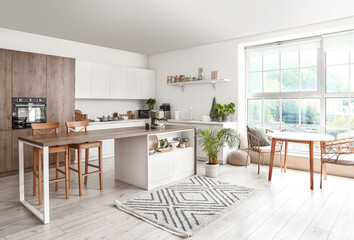 Interior of modern kitchen with coffee machine on wooden table