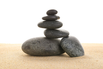 Fototapeta na wymiar Stack of zen stones on the sand isolated on white background.