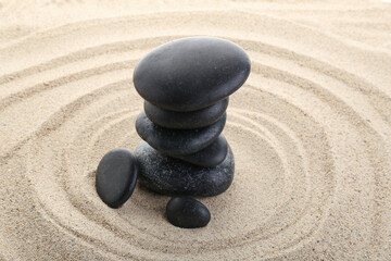 Fototapeta na wymiar Zen stones in the sand, concept of balance and harmony