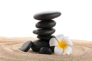 Foto op Aluminium Stack of zen stones with white flower on sand. Harmony with nature concept © Pixel-Shot