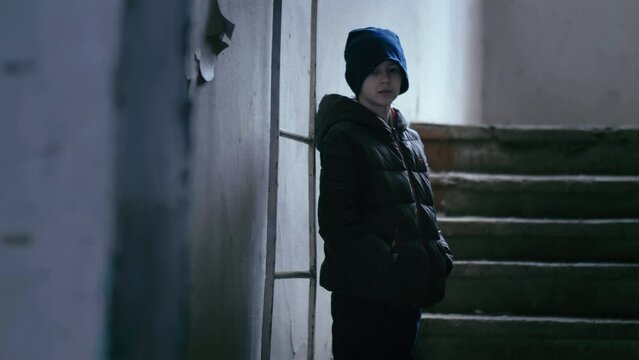 Playful Boy's Exploration: Seeking Hideout in Abandoned Building while Wiping His Nose