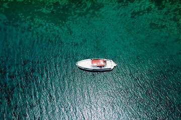 Aerial view of a small boat in the sea. View from above.