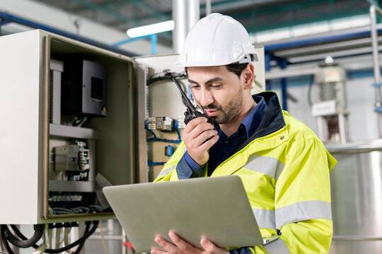 Mechanic or maintenance or electrical engineer checking main electrical control systems industrial plant. Utility fore man daily check power systems in process. Main Distribution Board, Switchboards