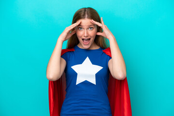 Super Hero caucasian woman isolated on blue background with surprise expression