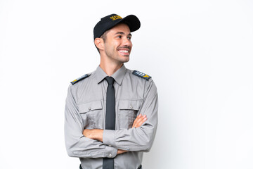 Young safeguard man over isolated white background with arms crossed and happy