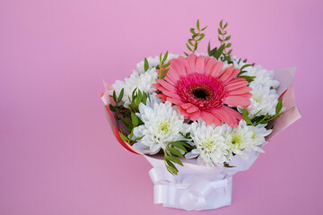 A beautiful bright bouquet of blooming fresh gerberas for a gift collected by an experienced florist