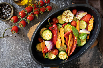 Grilled vegetables: red and yellow paprika, garlic, zucchini, eggplants, carrots in a frying pan on...