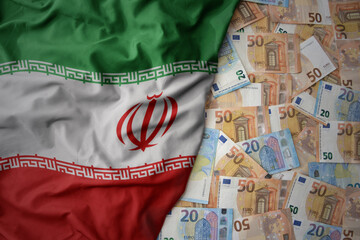colorful waving national flag of iran on a euro money background. finance concept