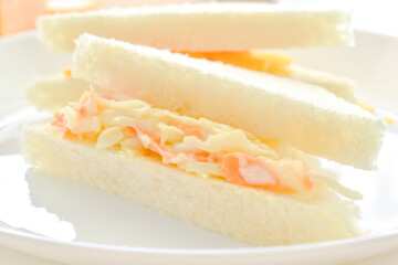 Coleslaw sandwich on a white plate. 