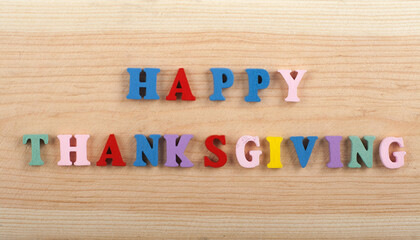 HAPPY THANKSGIVING word on wooden background composed from colorful abc alphabet block wooden...