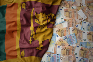 colorful waving national flag of sri lanka on a euro money background. finance concept