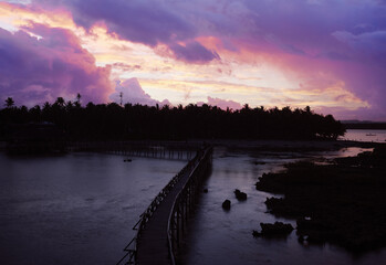 Dusk and down on the seashore. Wooden bridge on a beach, Siargao Island Philippines.