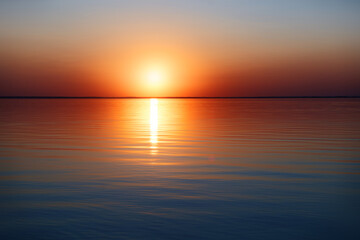Beautuful sunset on the sea with sun reflecting in water