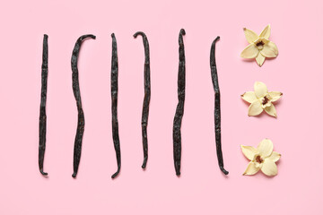 Aromatic vanilla sticks and flowers on pink background