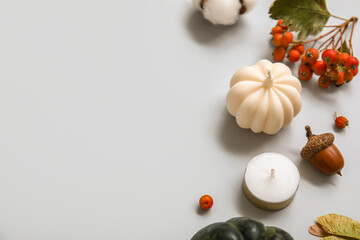 Composition with candles and autumn decor on grey background