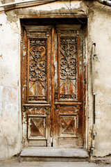 Old weathered wooden carved door, doorway
