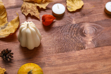Fototapeta premium Composition with candles and autumn decor on wooden background