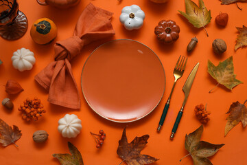 Beautiful table setting for Thanksgiving Day celebration on orange background